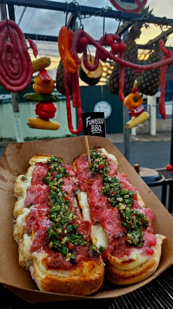 Choripans FUMASSOU servidos no pão ciabatta com queijo e chimichurri
